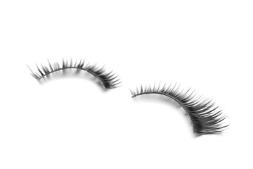 Beautiful pair of false eyelashes on white background