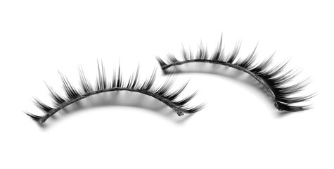 Beautiful pair of false eyelashes on white background