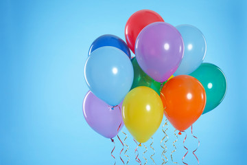 Bunch of bright balloons on color background. Space for text