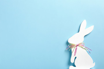 Easter bunny figure on color background, top view. Space for text