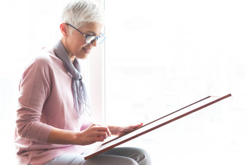 Woman writing on blackboard