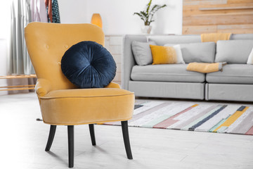Comfortable armchair with soft cushion in modern living room interior. Space for text