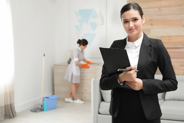 Housekeeping manager checking maid work in hotel room