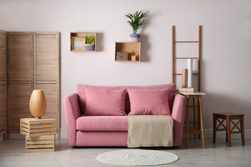 Modern living room interior with stylish pink sofa