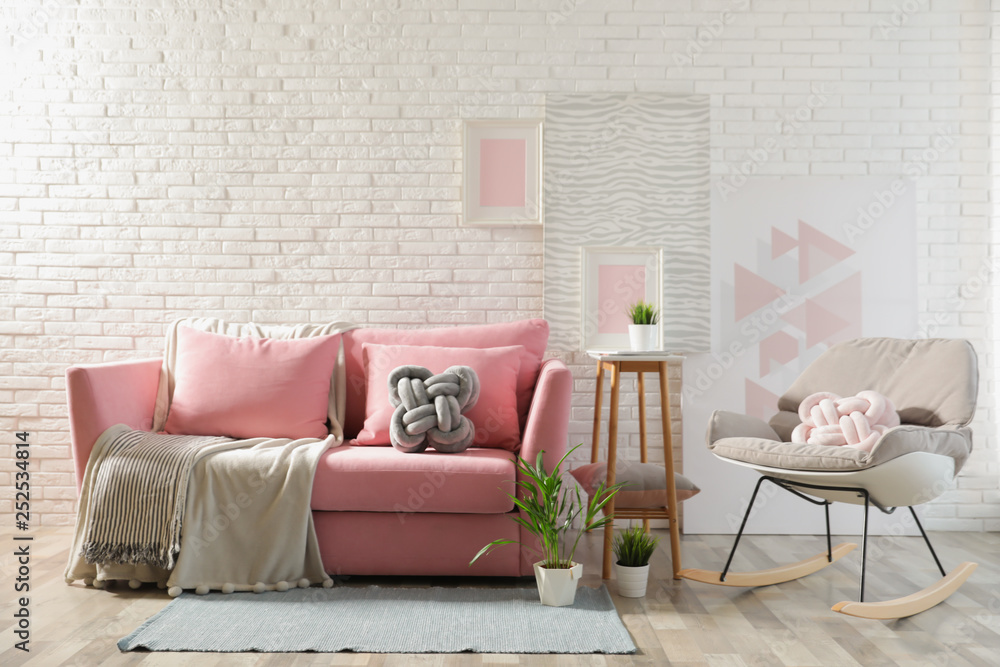 Canvas Prints Stylish living room interior with sofa and rocking armchair near brick wall