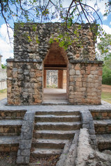 A unique triangular arch entry gate stands sentry behind the defensive walls surrounding Ek' Balam temple site