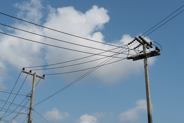 Electrical pole with many cable under blue sky. at Thailand.