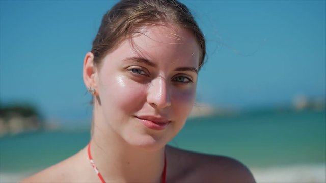 On a Tropical Beach Close-Up Portrait of European Beautiful Cute Brunette in with Sunglass Young Woman or Cheerful Girl Looking in The Camera, Blowing Wind Hair the Wind , Slow Motion.