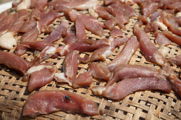 Red meat on wooden basket.