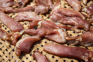 Red meat on wooden basket.