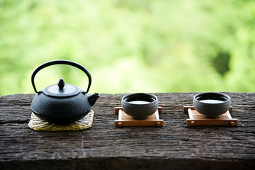 Obraz na płótnie Canvas set Chinese tea on the old wood table green nature background
