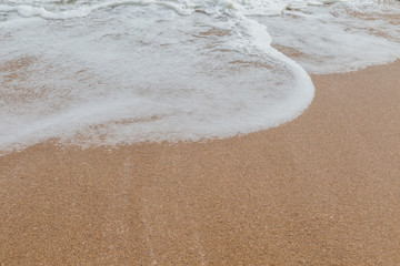 Wave of the sea on the sand beach