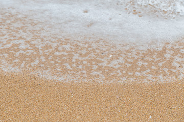 Wave of the sea on the sand beach