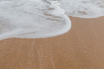 Wave of the sea on the sand beach