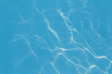 Blue pool water with sun reflections