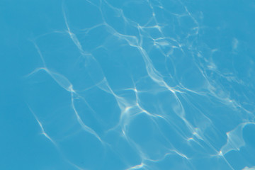 Blue pool water with sun reflections