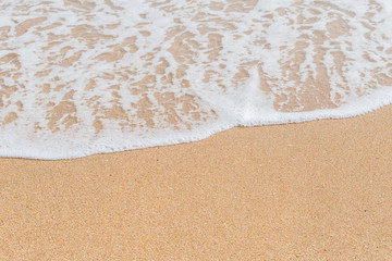 Wave of the sea on the sandy beach