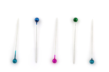 Color sewing push pins isolated on white
