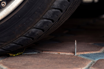 A nail in front of tyre to damage your transportation.