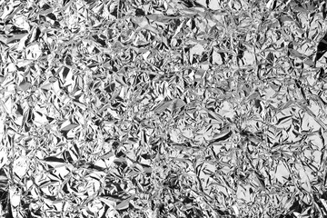 Crumpled silver foil shining texture background, bright shiny festive design, metallic glitter surface, holiday decoration backdrop concept, metal shimmer light effect, sparkling silver color pattern 