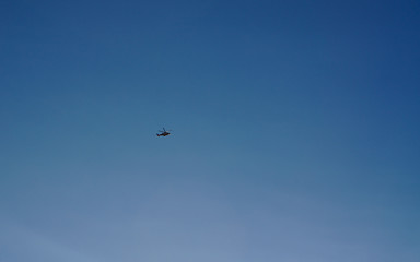 Naklejka na ściany i meble Helicopter flying with blue sky background