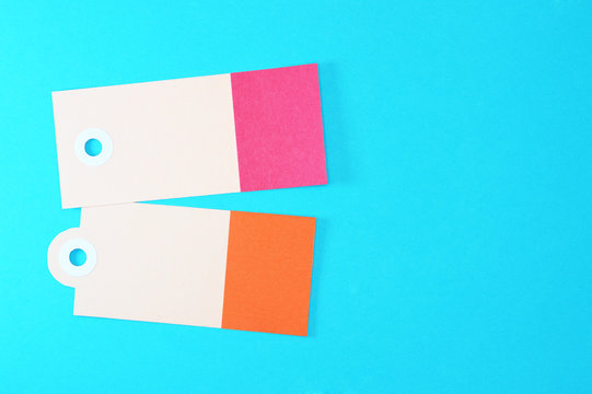 red and orange rectangle paper tags on blue background