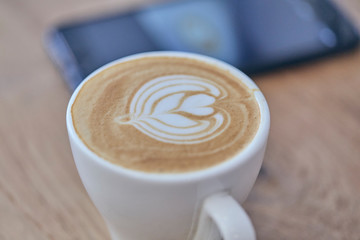 Art in coffee cup. Close up over view of art on coffee toppings . Selective focus