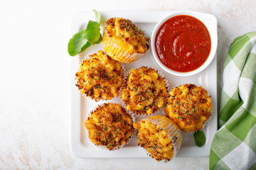 Baked mac and cheese muffins with marinara sauce