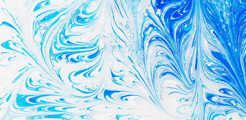 Abstract beautiful blue and white marble pattern.The Eastern style of Ebru painting on water with acrylic paints swirls marbling.A stylish mix of colors,genuine luxury