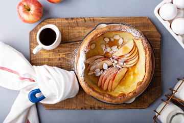 Dutch baby pancake with apples, powdered sugar and almonds