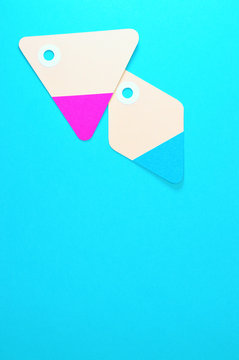 diamond and triangle paper tags on blue background vertical template