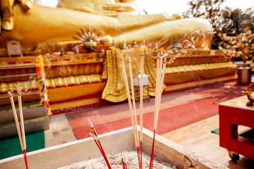 Symbols of Buddhism. Burning incense sticks. South-Eastern Asia. Details of buddhist temple in Thailand.