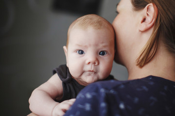 Baby in the arms of the mother.