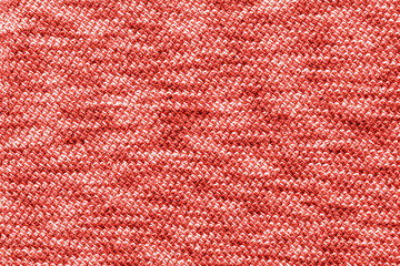Knitted Jersey fabric textile trendy colored of the year 2019, coral color background, texture
