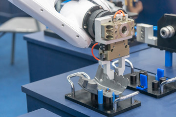 The robotic arm handing the metal press part production line with. The hi-technology automotive  parts manufacturing process  in industrial 4.0 concept.