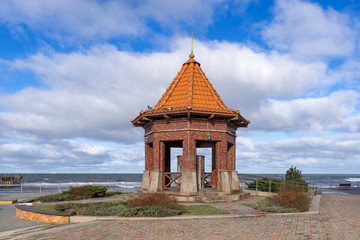 View of the stormy sea and the pump-room "Queen Louise" on the city boardwalk in Zelenogradsk, Kaliningrad region