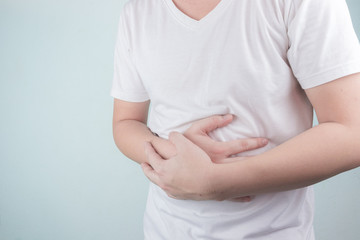 Asian Young men are suffering from stomach ulcers. gastritis Caused by the infection of H. pylori bacteria  healthcare and health problem concept