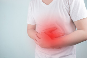 Asian Young men are suffering from stomach ulcers. gastritis Caused by the infection of H. pylori bacteria  healthcare and health problem concept