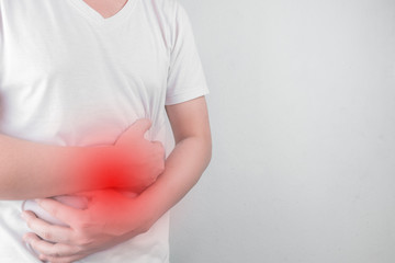 Asian Young men are suffering from stomach ulcers. gastritis Caused by the infection of H. pylori bacteria  healthcare and health problem concept