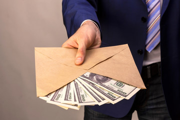 A man who conceals his identity transfers the money in an envelope. Concept on the theme of...