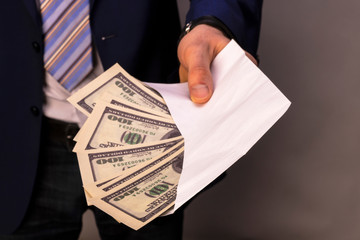 A man who conceals his identity transfers the money in an envelope. Concept on the theme of...