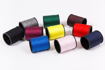 Spools of colorful thread as accessories for using in sewing.