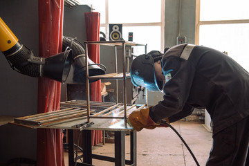 The welder makes the part. Worker welds the details. Master of semi-automatic welding.