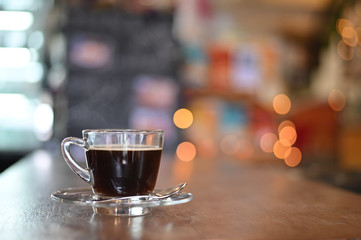 Coffee cup on wood table in cafe.
