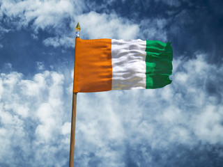 Cote d'Ivoire flag Silk waving flag of Ivory Coast made transparent fabric with wooden flagpole gold spear on background blue sky white smoke clouds real retro photo Countries of world 3d illustration