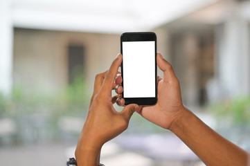 Mockup mobile phone on hands with blur background.