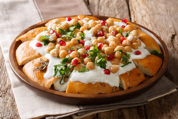 Homemade breakfast of pita with chickpeas, yogurt and pomegranate seeds close-up on a plate. horizontal