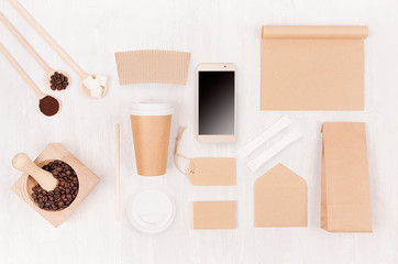 Coffee takeaway set mockup for brand - brown paper cup, blank phone, notebook, packet, label, mortar with beans, sugar on white wood board.