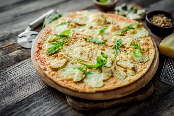 Pizza four cheeses on the table