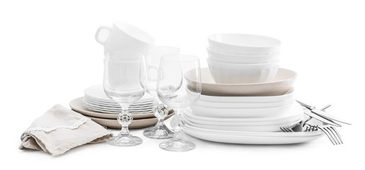 Set of white ceramic dishes and shiny glasses